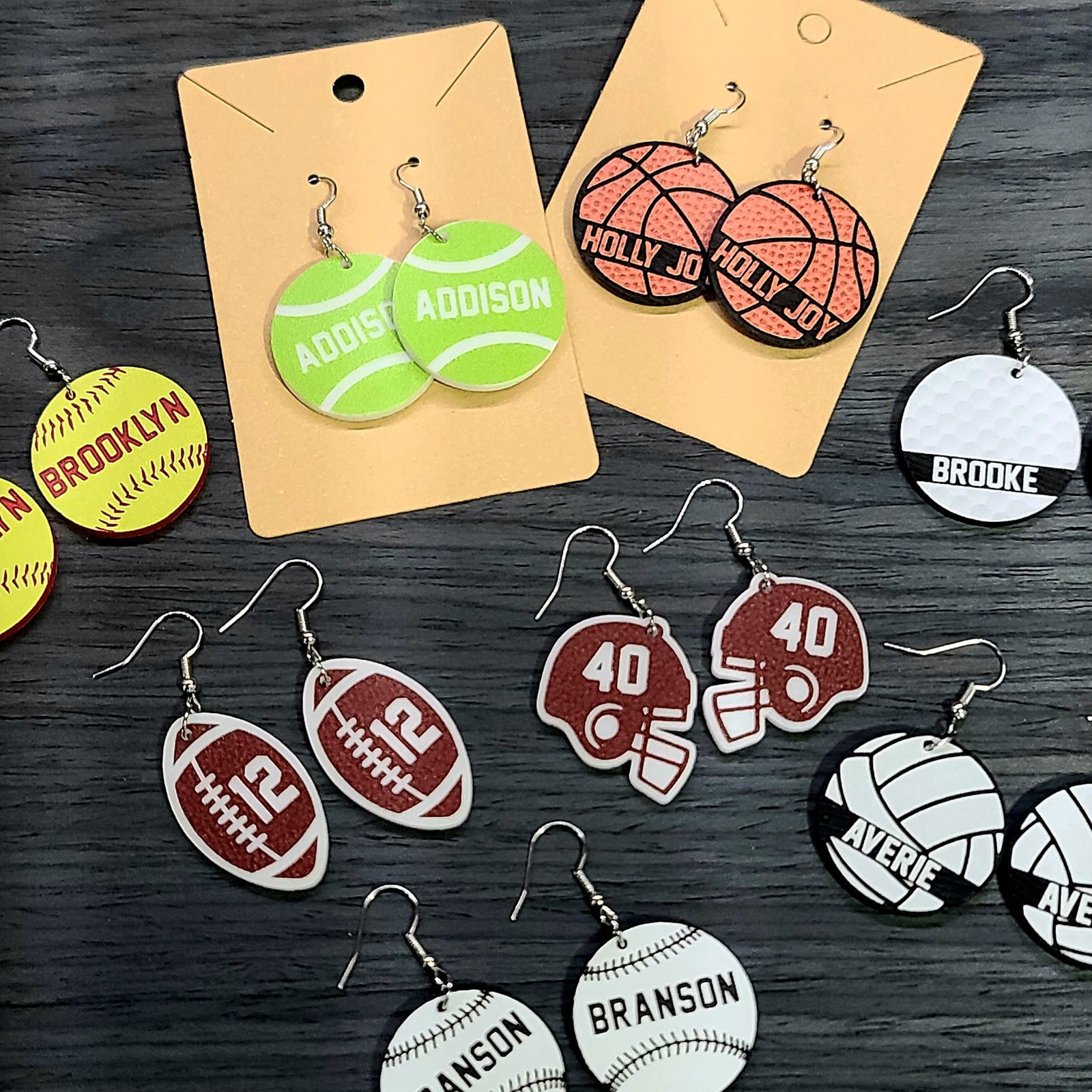 Assorted personalized sports earrings on display cards