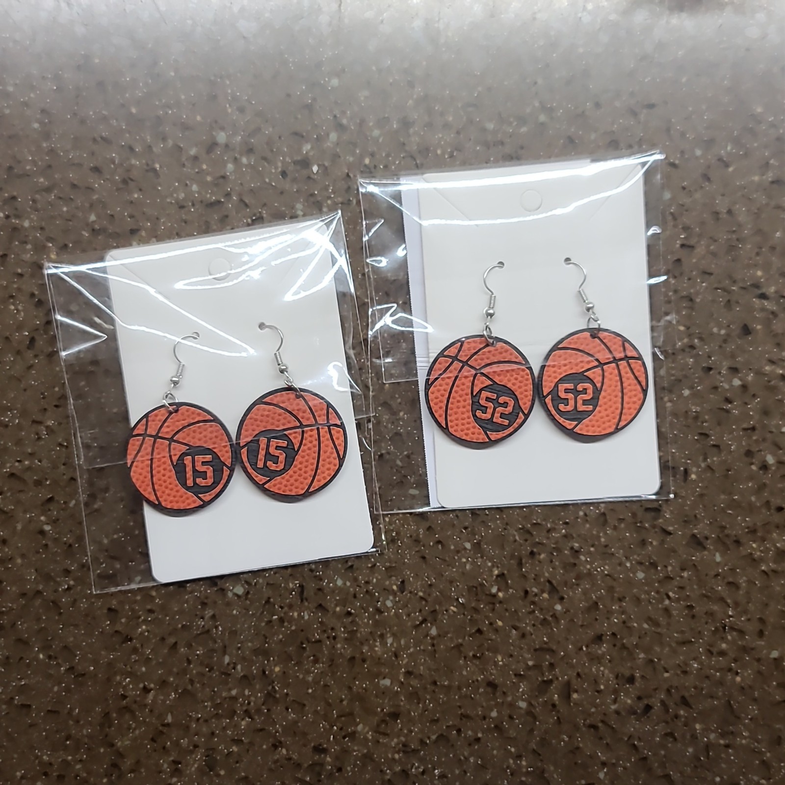 Basketball earrings with jersey numbers 15 and 50