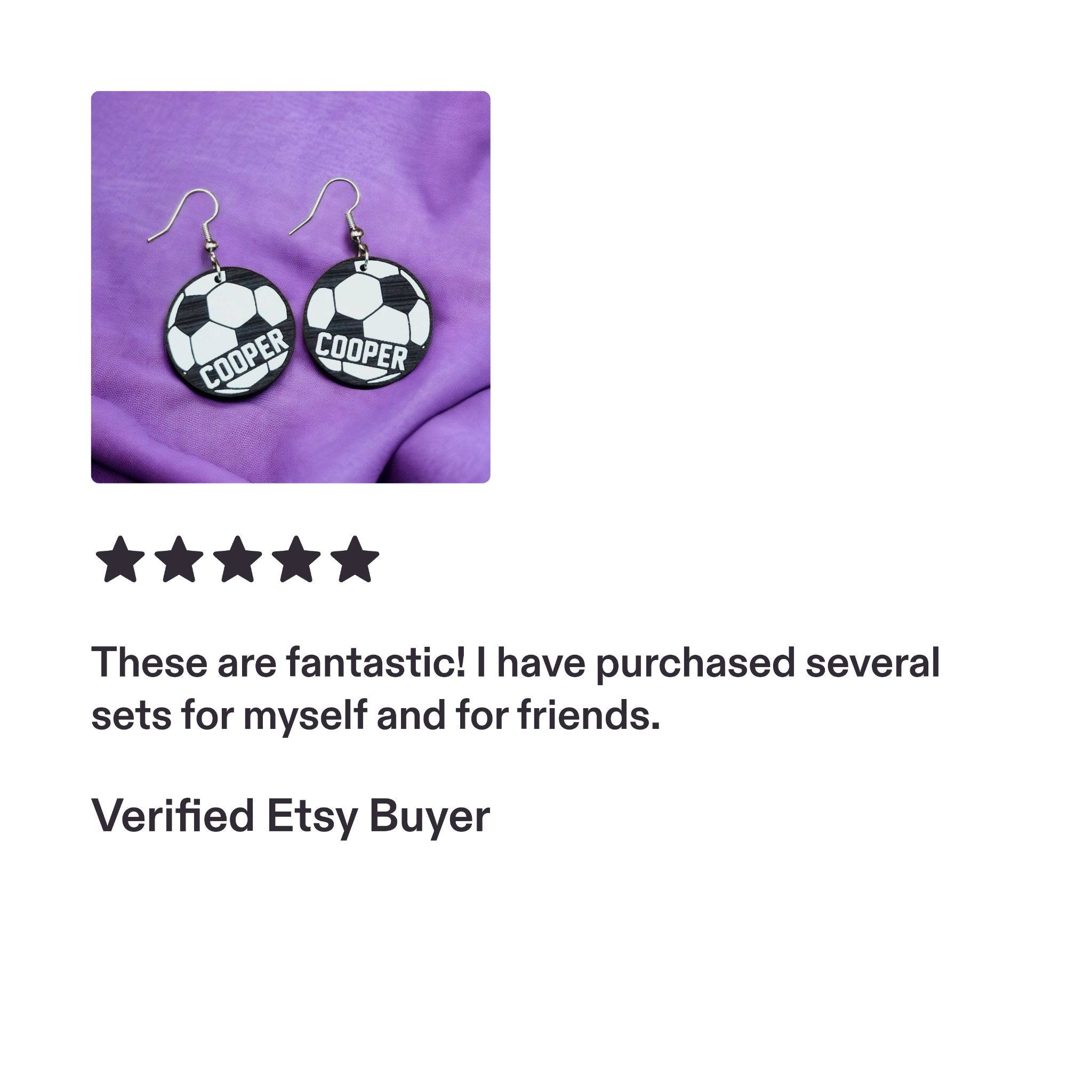 Personalized COOPER soccer earrings on purple fabric.